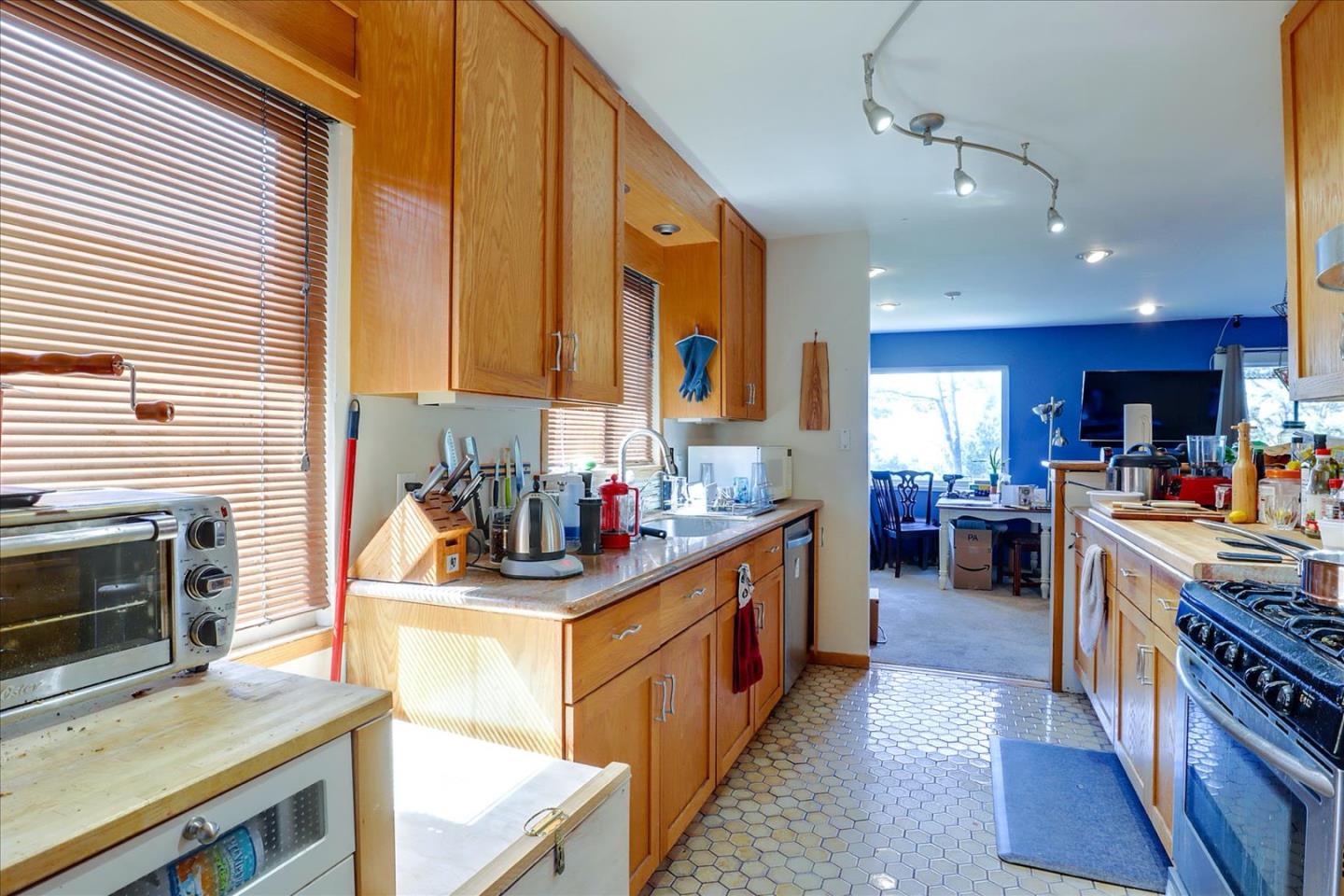 6821 Ridgewood Drive Oakland, CA 94611 - Photo 6 of 26 a kitchen with stainless steel appliances a sink stove and cabinets