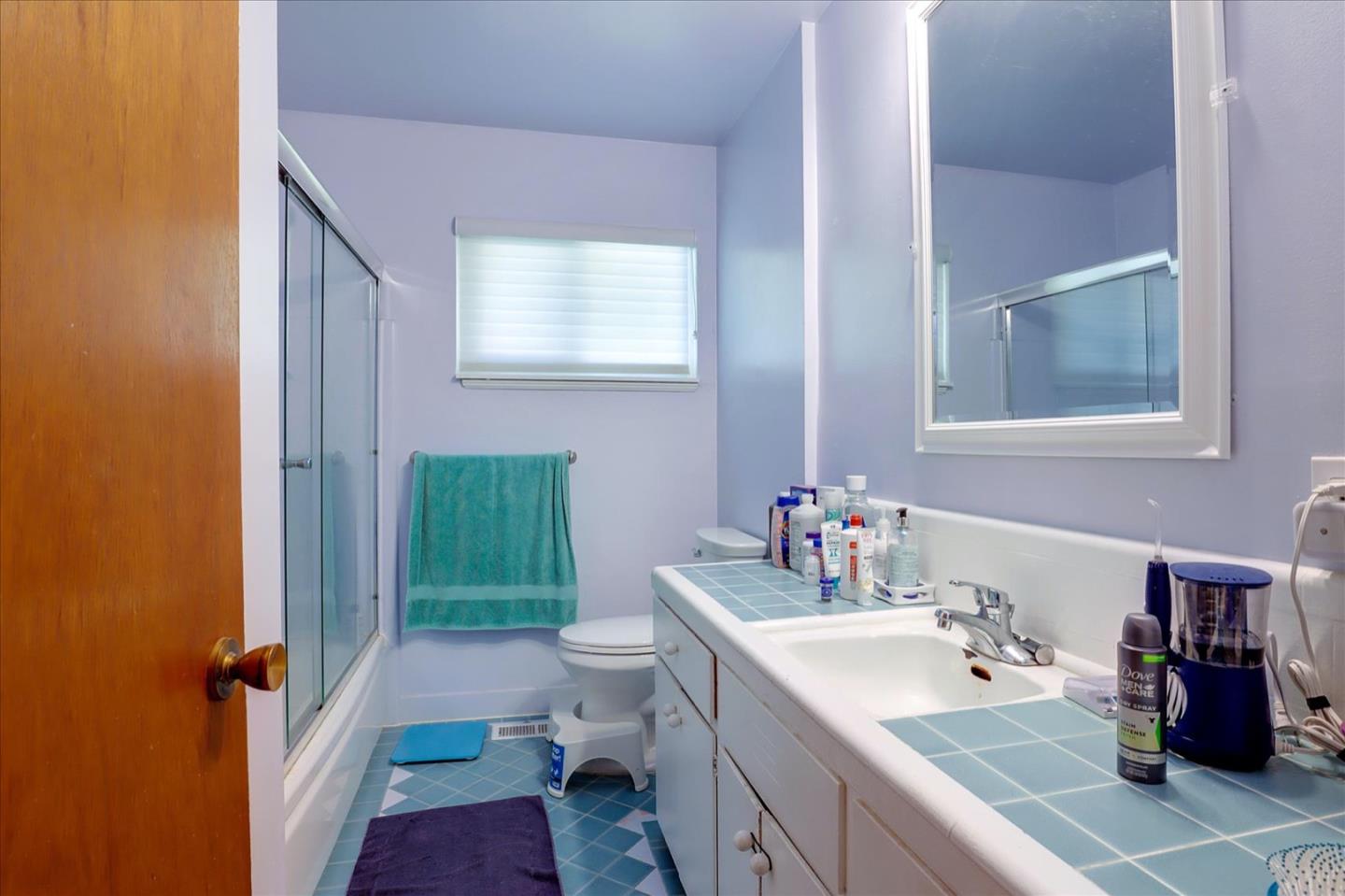 6821 Ridgewood Drive Oakland, CA 94611 - Photo 8 of 26 a bathroom with a sink a toilet and shower