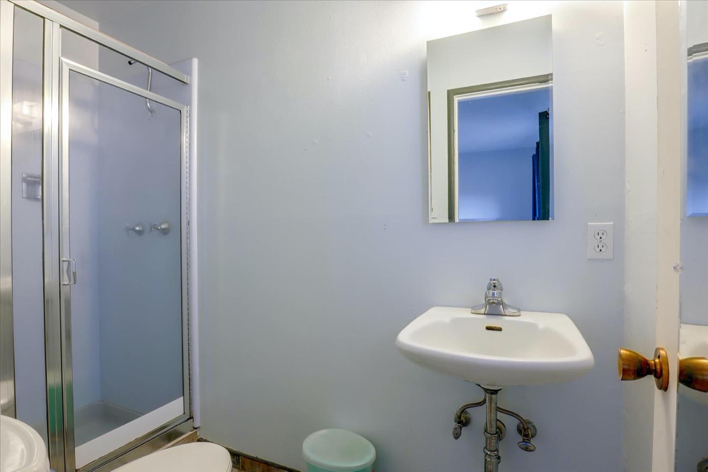 6821 Ridgewood Drive Oakland, CA 94611 - Photo 9 of 26 a bathroom with a sink and mirror