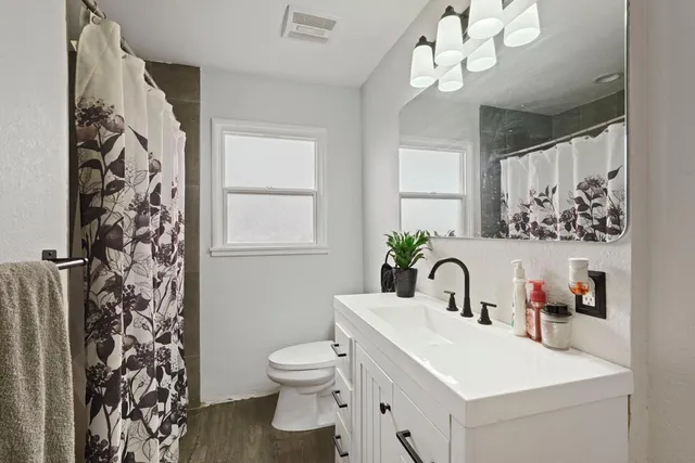 a bathroom with a sink toilet and shower