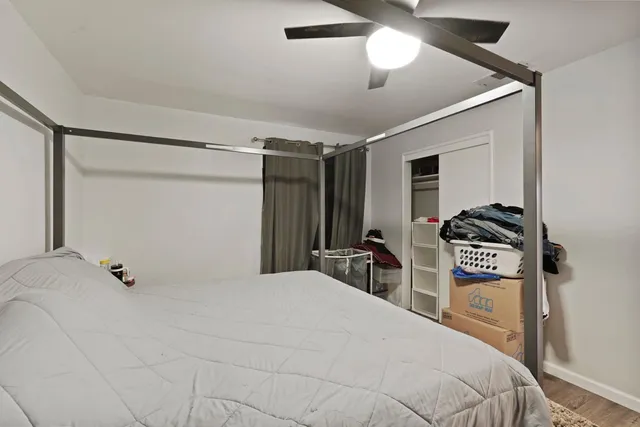 a bedroom with a bed and a chandelier