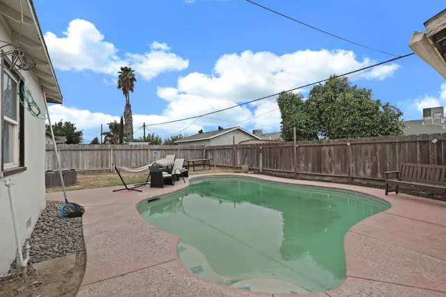a view of a swimming pool with a patio
