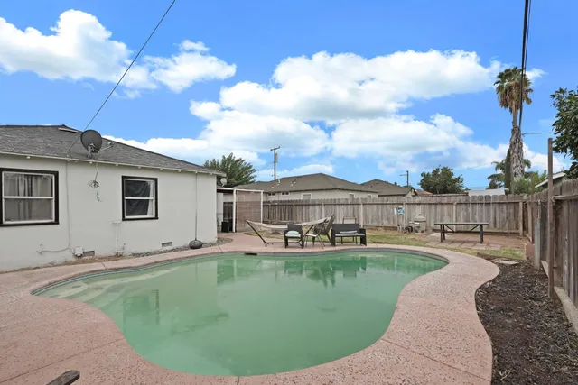 a view of a house with a backyard porch and sitting area