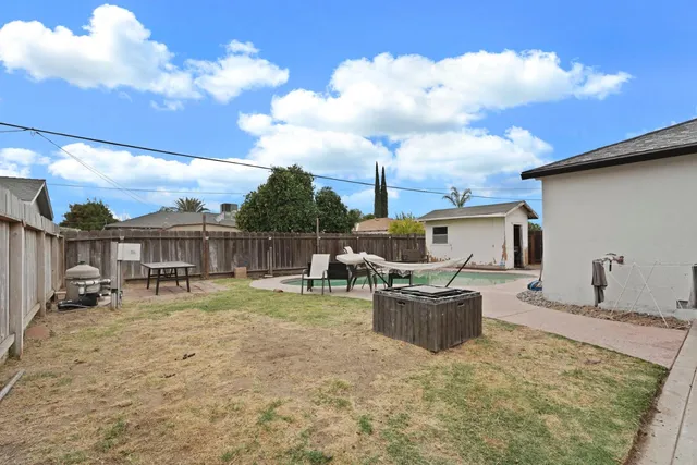 a front view of a house with sitting area and garden