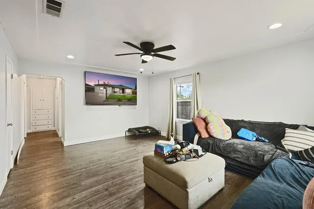 a living room with furniture and wooden floor