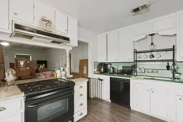 a kitchen with stainless steel appliances a stove and cabinets