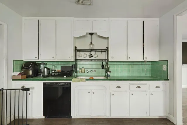 a kitchen with stainless steel appliances granite countertop a stove and cabinets