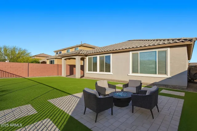 a view of a patio with couches table and chairs and potted plants