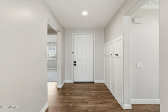 a view of a hallway with wooden floor