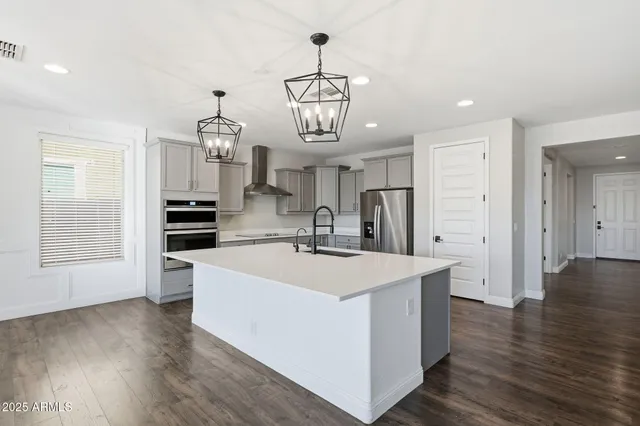 a view of kitchen with sink microwave and refrigerator
