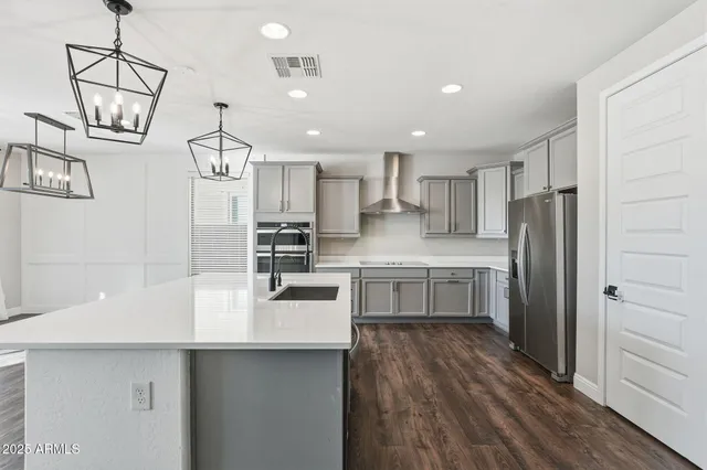 a kitchen with refrigerator and cabinets