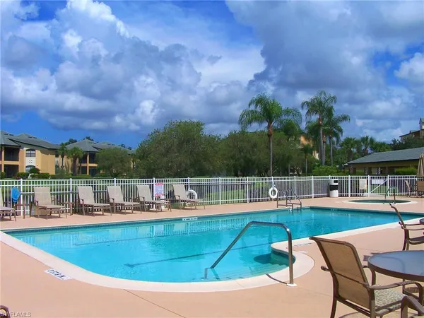 a view of a swimming pool with outdoor seating
