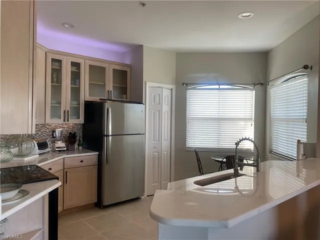a kitchen with a sink a stove and refrigerator