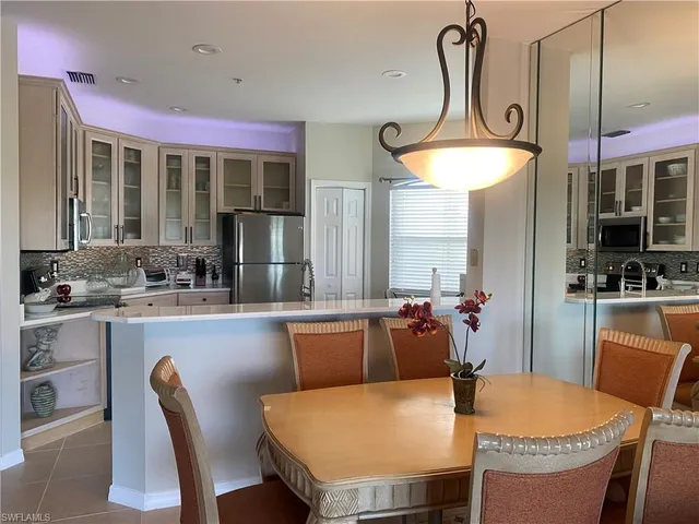 a dining table chairs and a chandelier