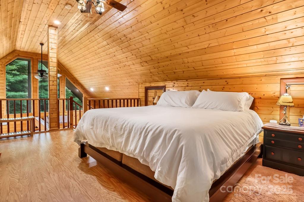 4271 Old Field Creek Road Grassy Creek, NC 28631 - Photo 20 of 27 a bed sitting in a bedroom next to a lamp