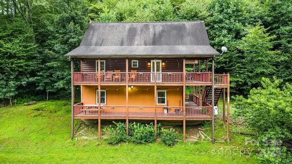 a aerial view of a house with a yard and sitting area