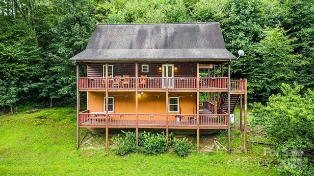 a aerial view of a house with a yard and sitting area