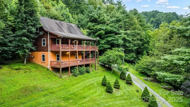 a aerial view of a house with a yard table and chairs