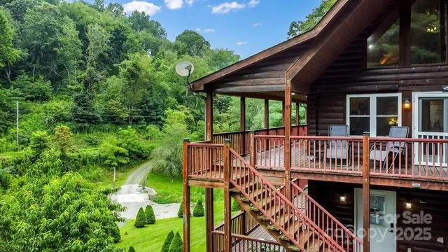 a view of a wooden deck with chairs and a yard