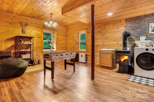 a living room with furniture a fireplace and wooden floor