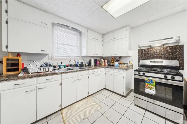 a kitchen with granite countertop cabinets stainless steel appliances and a sink