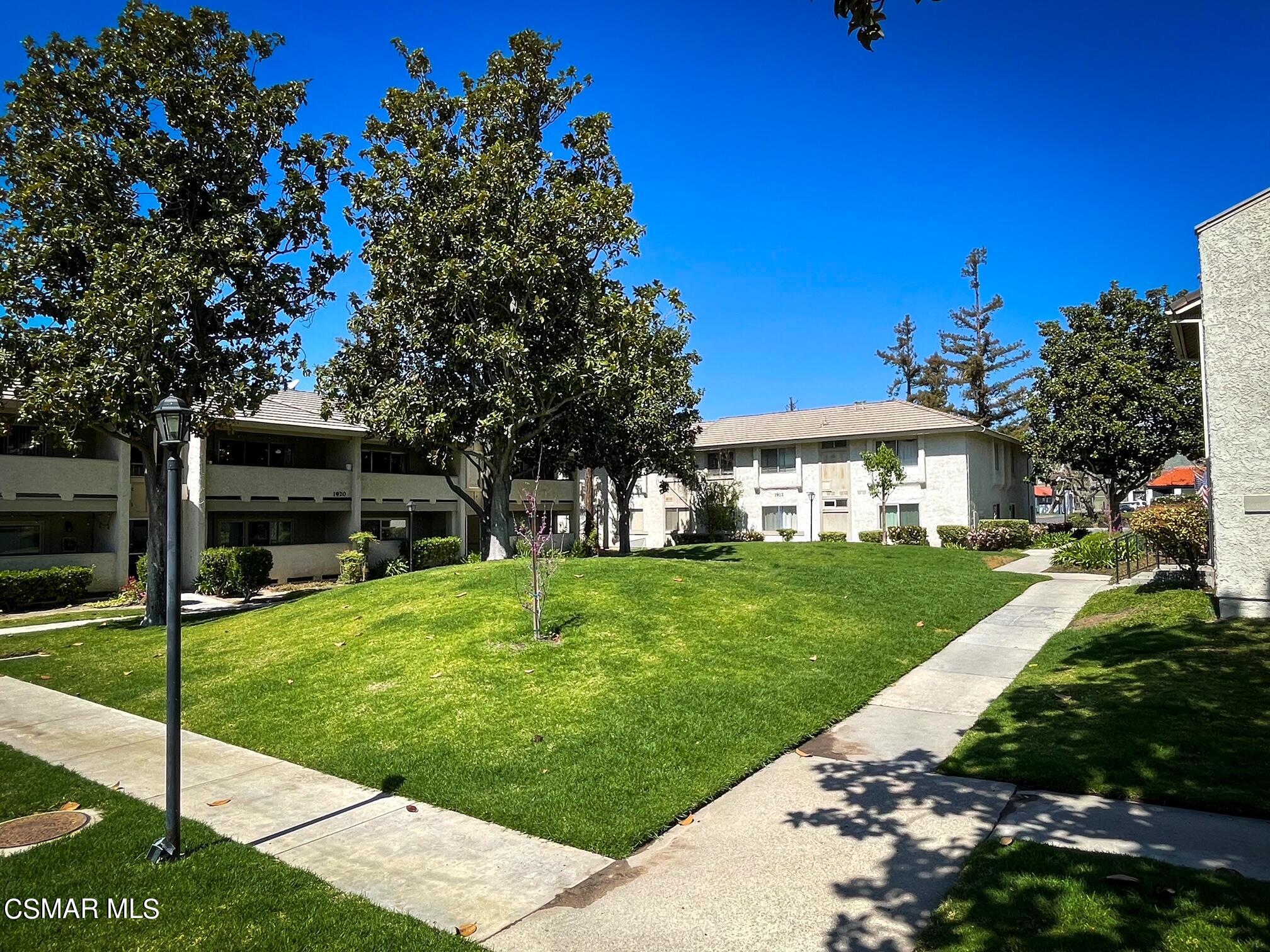 a view of house with a yard