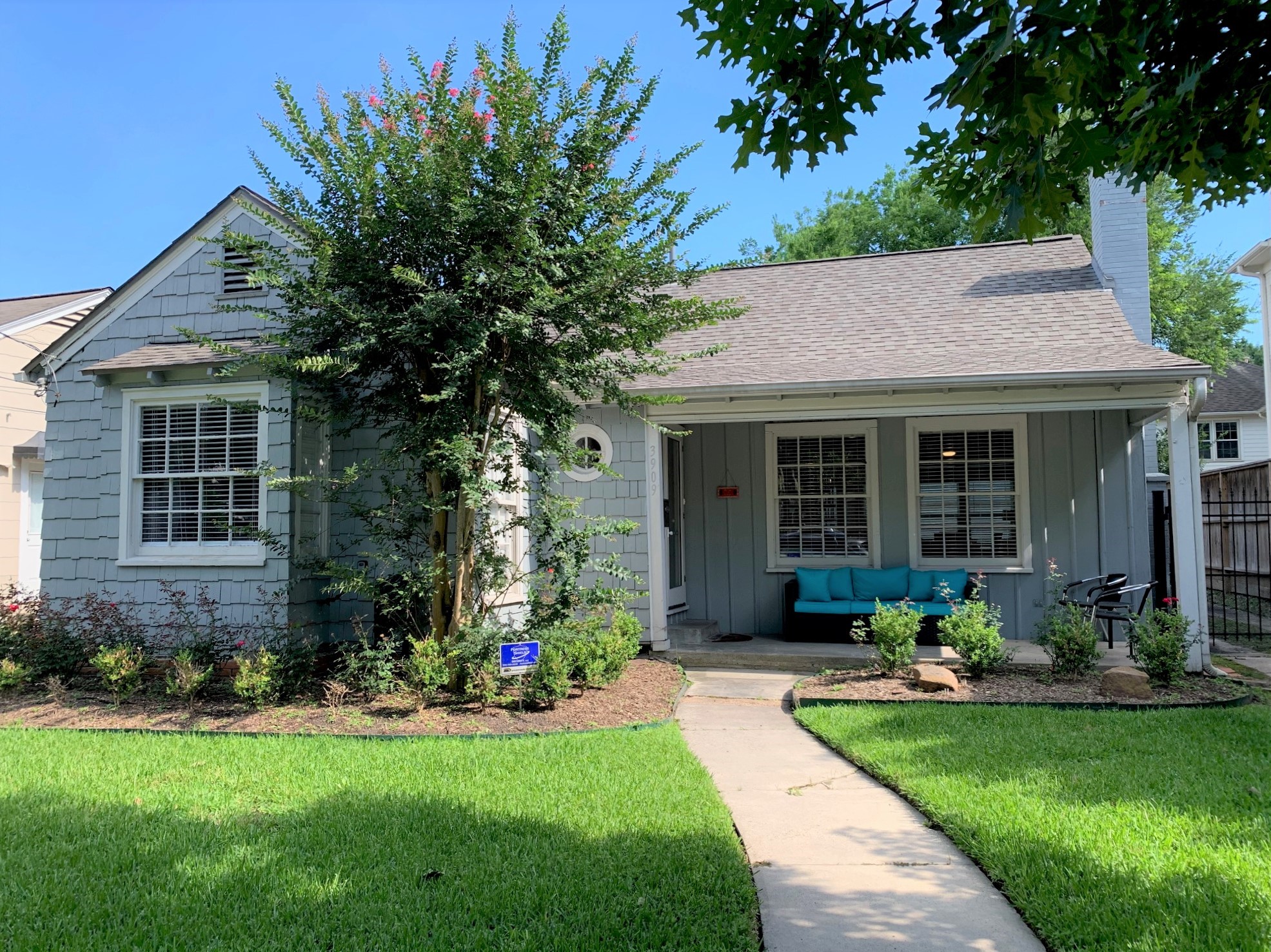 3909 Rice Boulevard Houston, TX 77005 - Photo 1 of 17 a front view of a house with a yard and porch