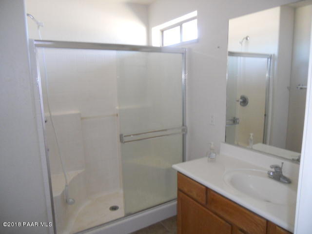 25725 Poppy Road Paulden, AZ 86334 - Photo 8 of 13 a bathroom with a granite countertop sink and shower