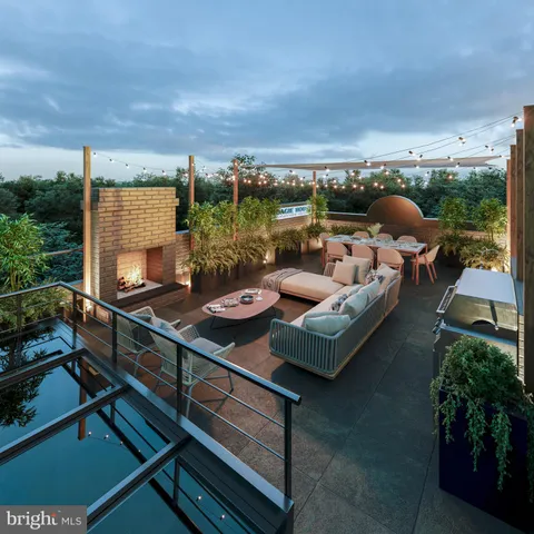 a view of a terrace with furniture and a garden
