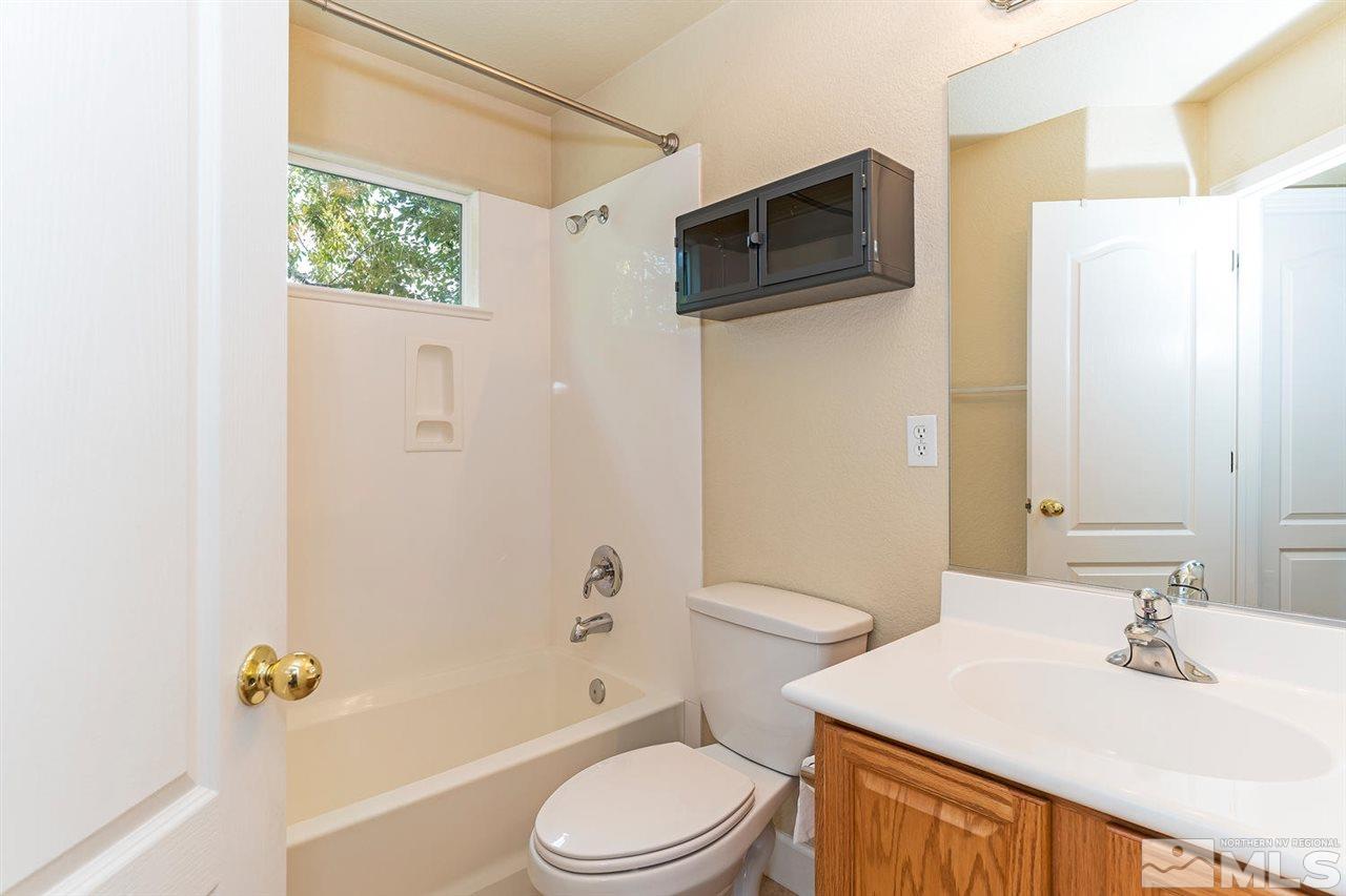 441 Mt Rose Street Reno, NV 89509 - Photo 17 of 21 a bathroom with a sink a toilet a mirror and shower