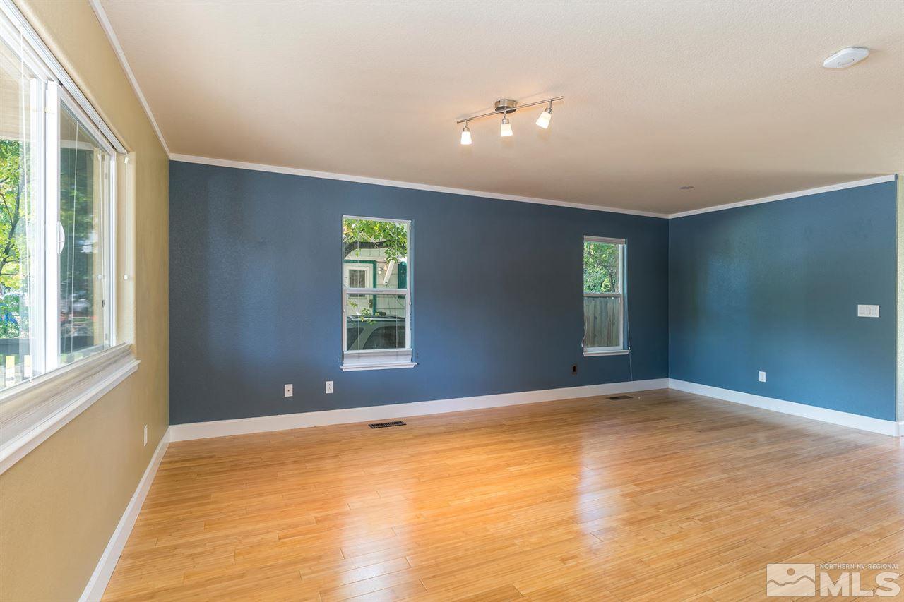 441 Mt Rose Street Reno, NV 89509 - Photo 3 of 21 a view of an empty room with window and wooden floor