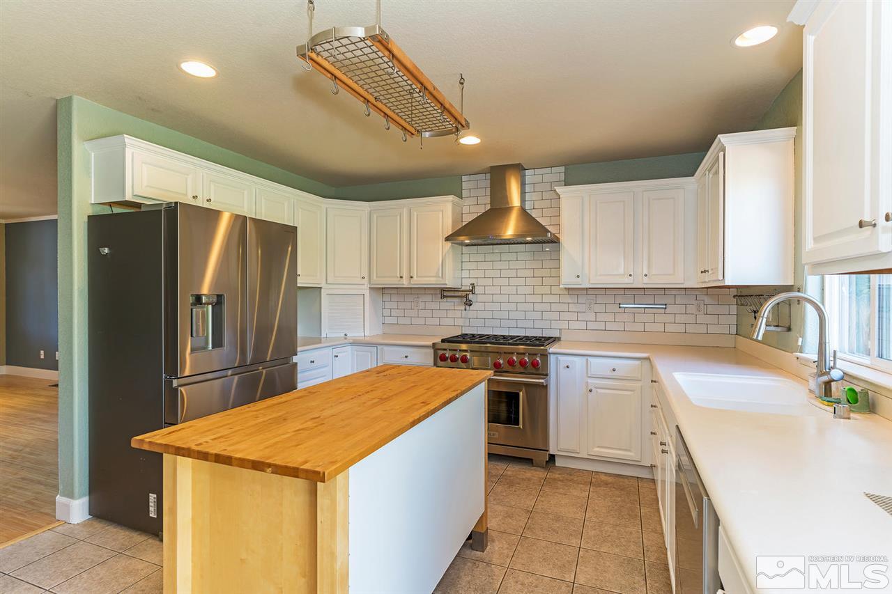 441 Mt Rose Street Reno, NV 89509 - Photo 10 of 21 a kitchen with stainless steel appliances granite countertop a sink stove and refrigerator