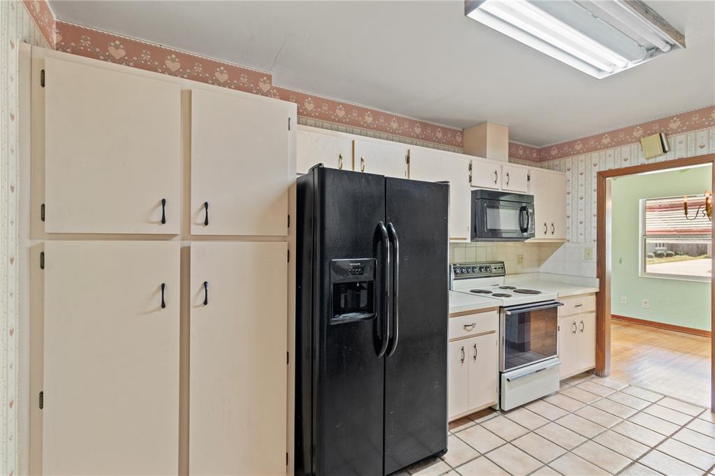 2236 Southeast 8th Avenue Ocala, FL 34471 - Photo 11 of 49 a kitchen with stainless steel appliances a refrigerator sink and cabinets