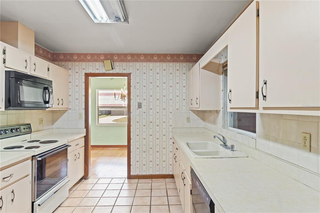 2236 Southeast 8th Avenue Ocala, FL 34471 - Photo 12 of 49 a kitchen with a sink stove and refrigerator