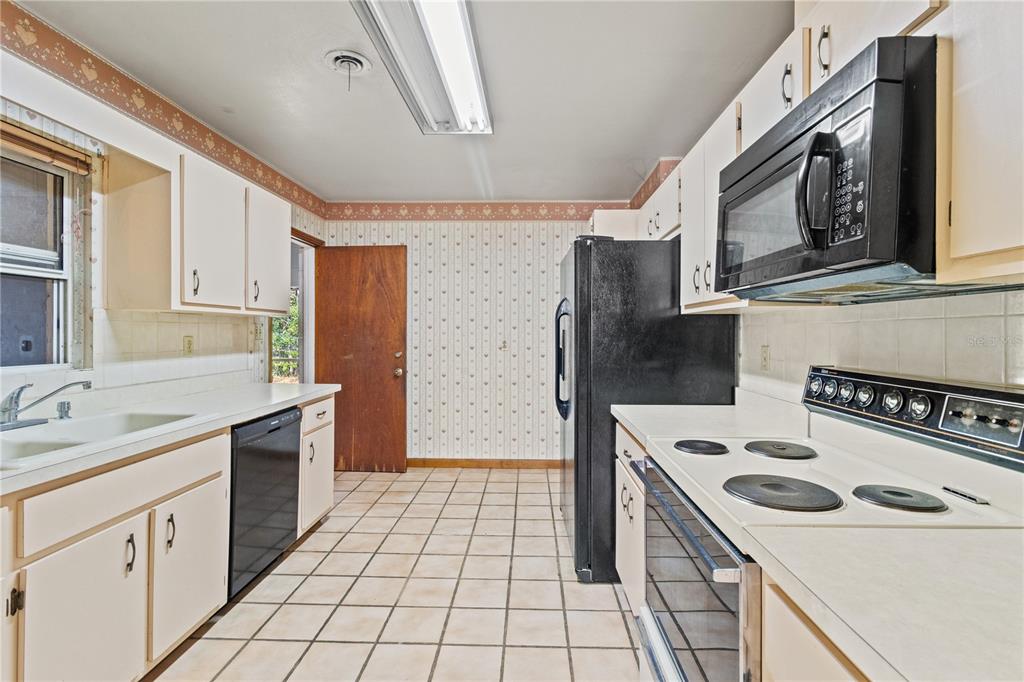 2236 Southeast 8th Avenue Ocala, FL 34471 - Photo 13 of 49 a kitchen with a sink stove and refrigerator