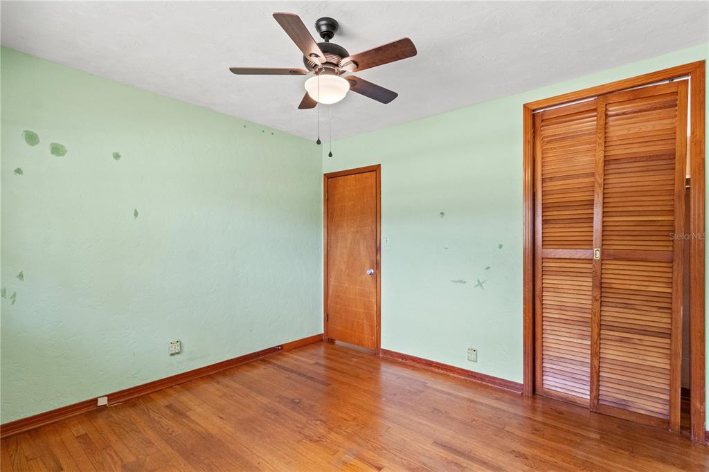 2236 Southeast 8th Avenue Ocala, FL 34471 - Photo 15 of 49 an empty room with wooden floor and a ceiling fan