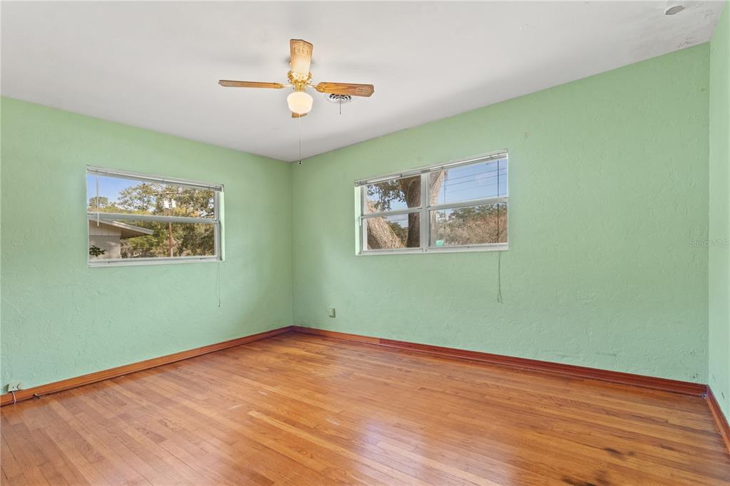 2236 Southeast 8th Avenue Ocala, FL 34471 - Photo 20 of 49 a view of a room with wooden floor and a ceiling fan