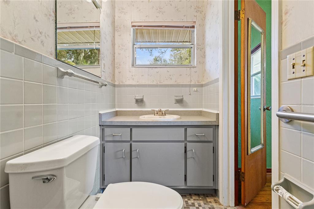 2236 Southeast 8th Avenue Ocala, FL 34471 - Photo 26 of 49 a bathroom with a toilet sink and mirror
