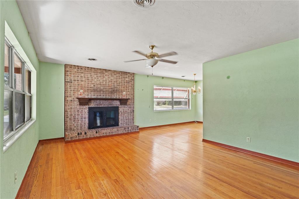 2236 Southeast 8th Avenue Ocala, FL 34471 - Photo 7 of 49 wooden floor fireplace and windows in an empty room
