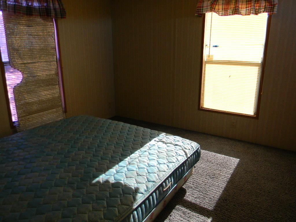 4180 Stirrup Road Snowflake, AZ 85937 - Photo 7 of 11 a bedroom with a bed and a window