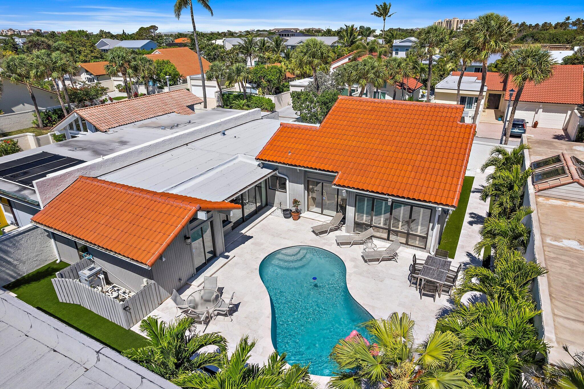 an aerial view of a house with yard swimming pool and outdoor seating