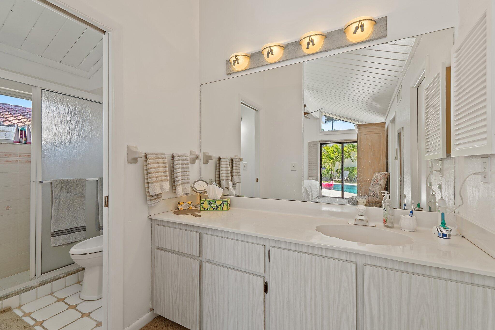 131 Bonefish Circle Jupiter, FL 33477 - Photo 24 of 48 a bathroom with a sink a toilet and shower