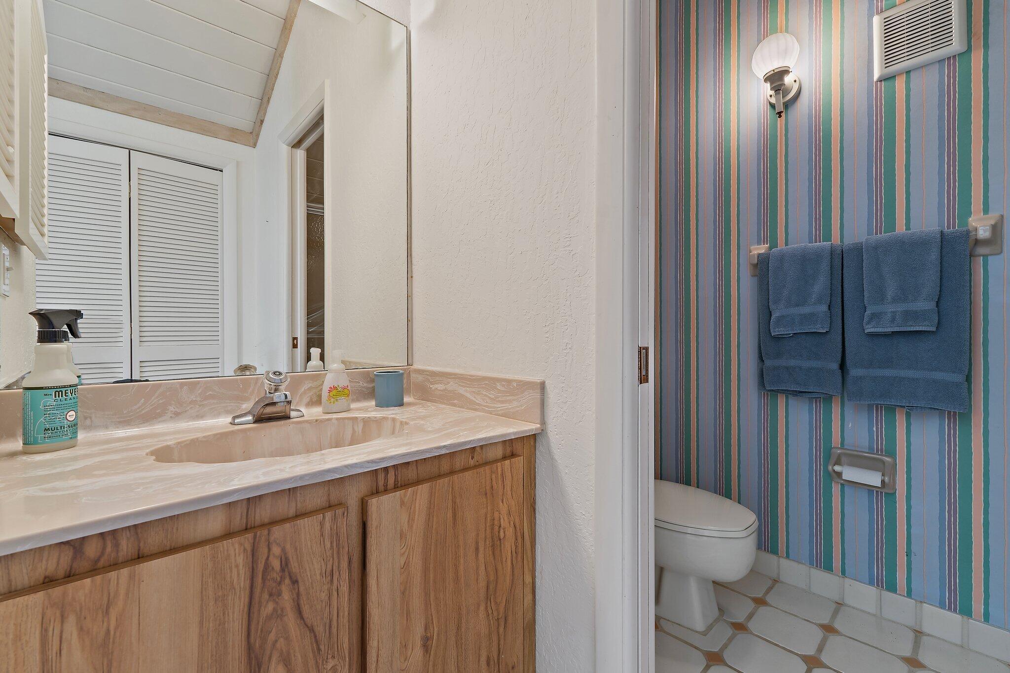 131 Bonefish Circle Jupiter, FL 33477 - Photo 33 of 48 a bathroom with a granite countertop sink toilet and mirror