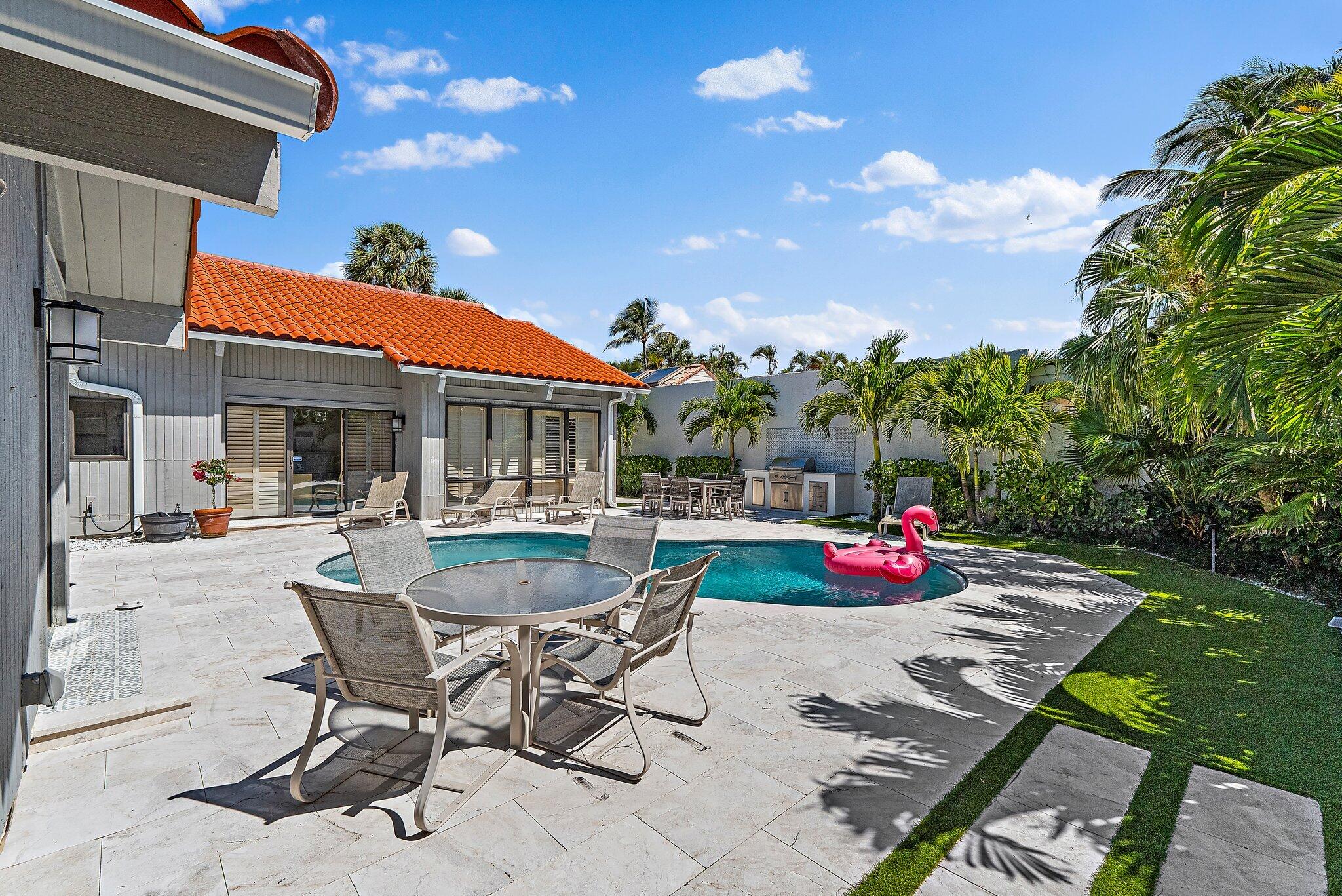 131 Bonefish Circle Jupiter, FL 33477 - Photo 37 of 48 a view of a patio with table and chairs and potted plants