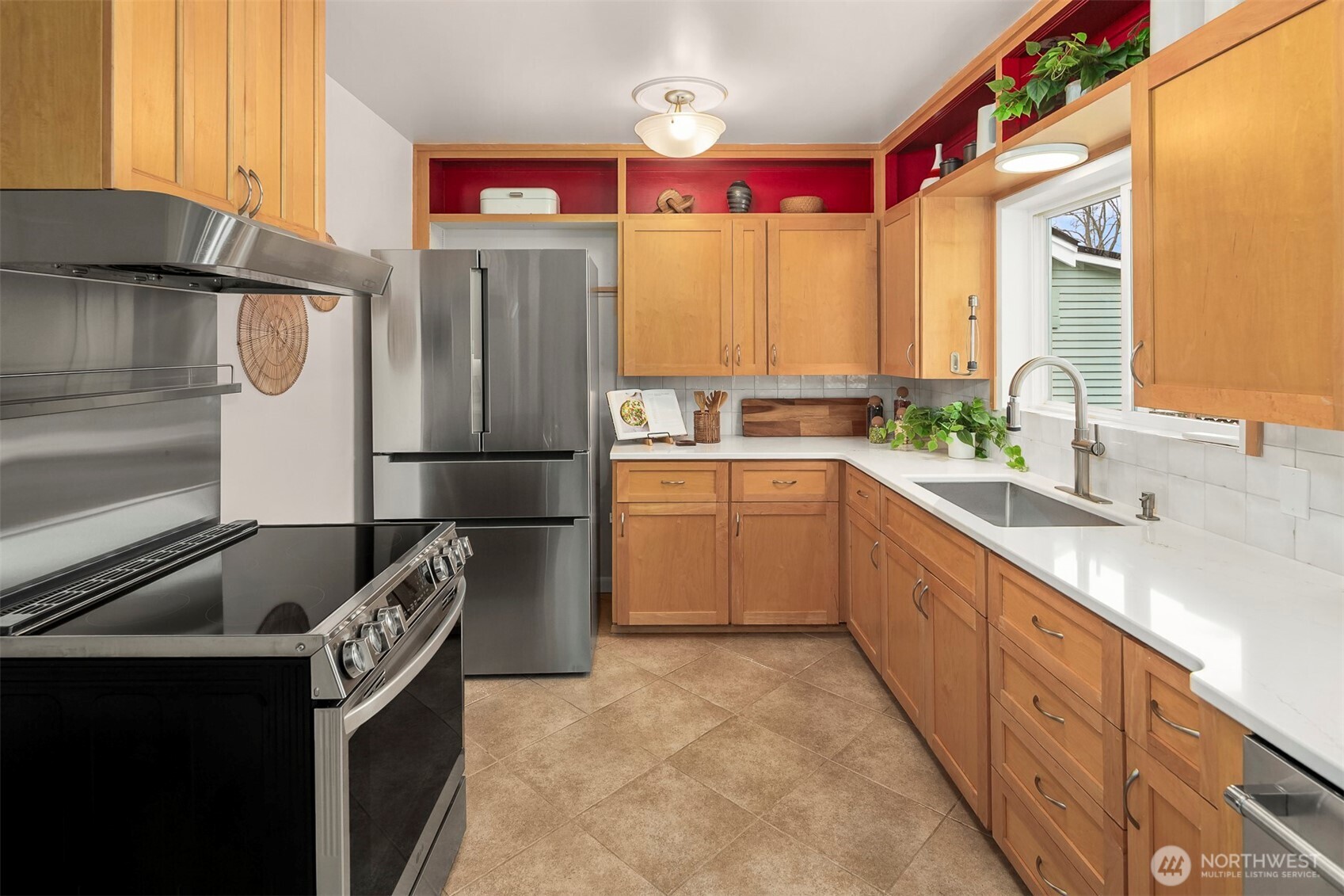6939 Fauntleroy Way Southwest Seattle, WA 98136 - Photo 11 of 35 a kitchen with stainless steel appliances granite countertop a sink stove and refrigerator