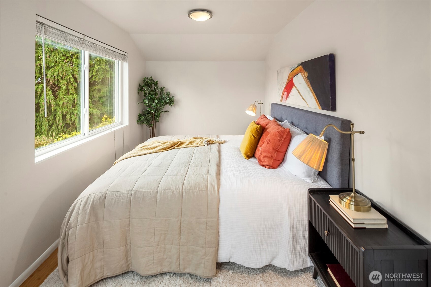 6939 Fauntleroy Way Southwest Seattle, WA 98136 - Photo 17 of 35 a bedroom with a bed and a potted plant