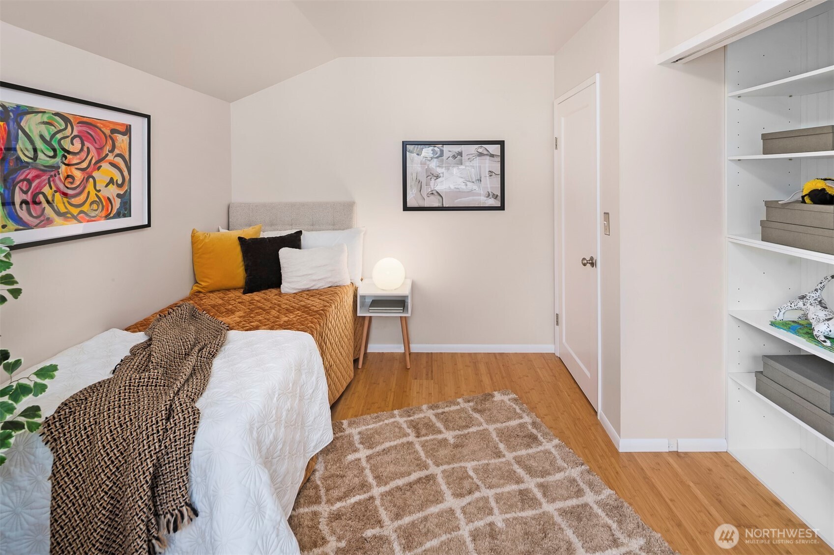 6939 Fauntleroy Way Southwest Seattle, WA 98136 - Photo 19 of 35 a bedroom with a bed and painting on the wall