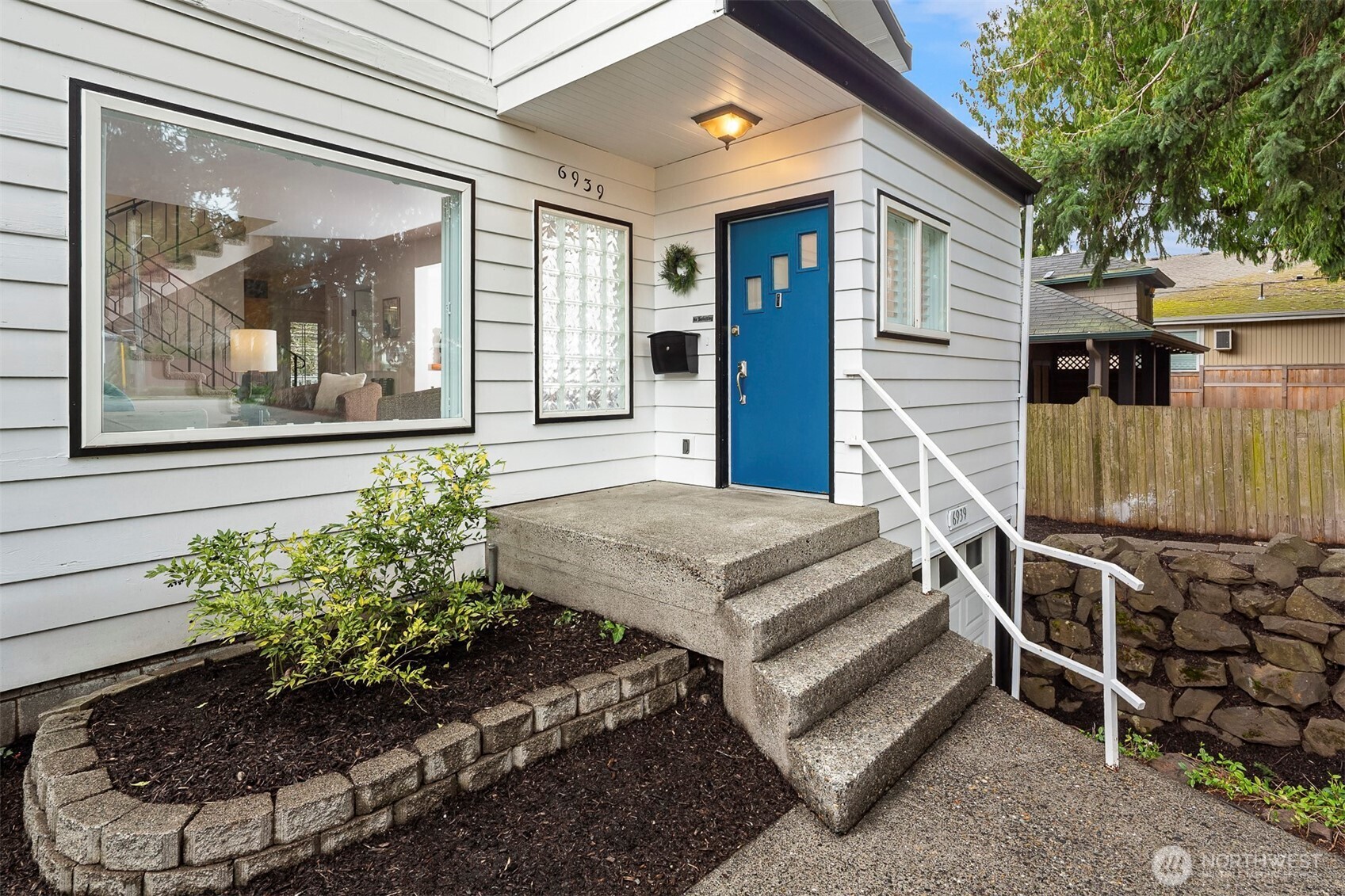 6939 Fauntleroy Way Southwest Seattle, WA 98136 - Photo 3 of 35 a front view of a house with a garden