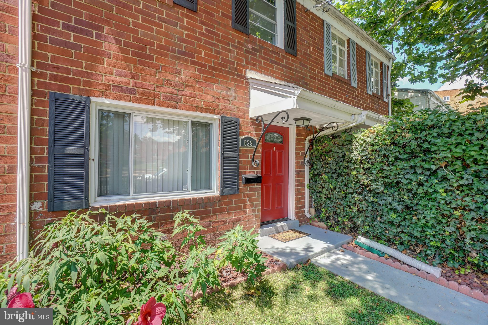 628 Four Mile Road Alexandria, VA 22305 - Photo 3 of 29 a front view of a house with a garden