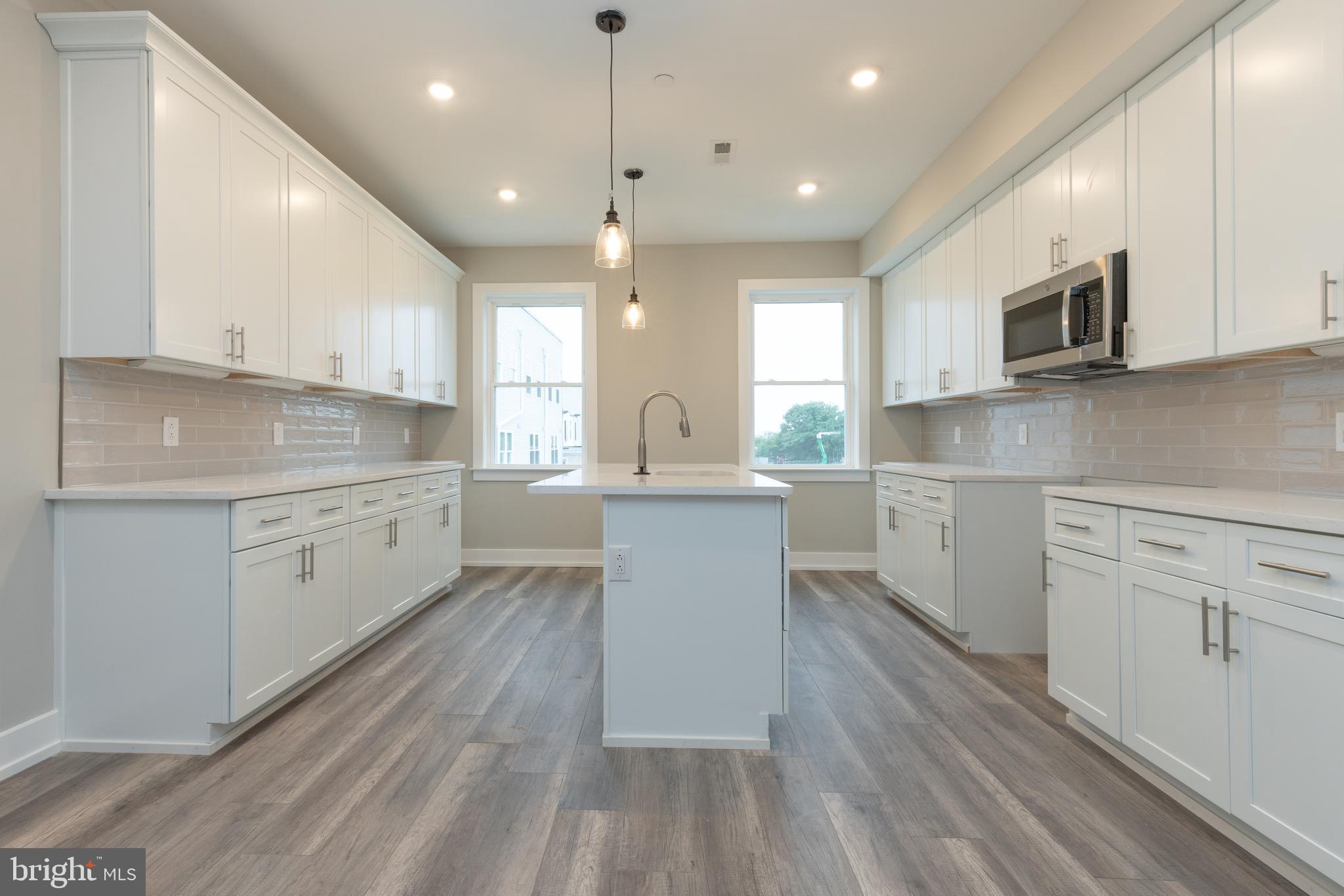 140 West Huntingdon Street, Unit 2 Philadelphia, PA 19133 - Photo 5 of 28 a kitchen with a white wooden cabinets and white stainless steel appliances